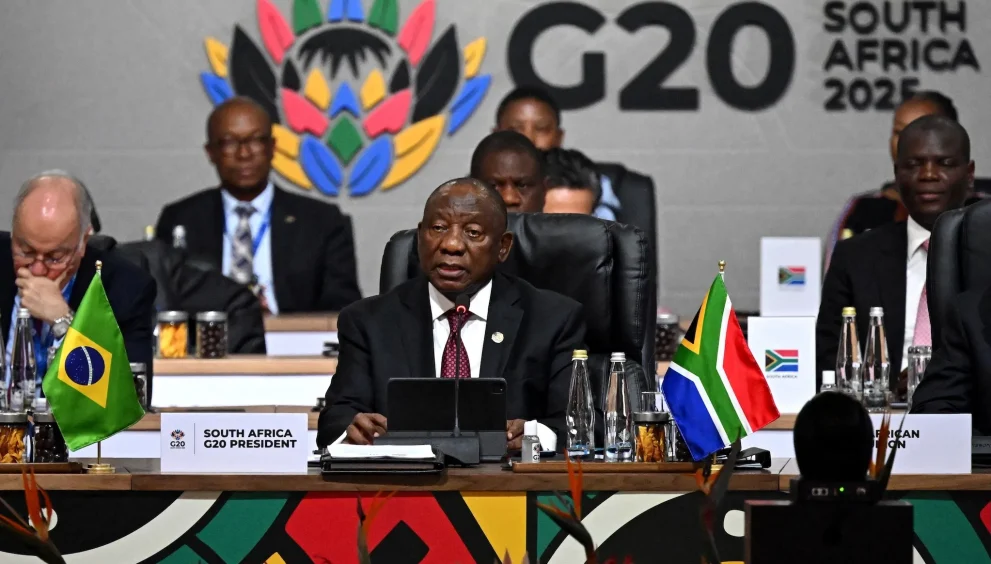 The Group of 20 summit in South Africa adopted a joint declaration on climate action, debt relief, and broader global challenges, despite the absence of the United States and differing views among several members. The document was completed after negotiations that proceeded without U.S. involvement, marking a departure from the G20’s traditional reliance on full consensus. South African officials said the text could not be renegotiated, noting that it reflected months of work and that participating members had reached what they considered sufficient agreement.