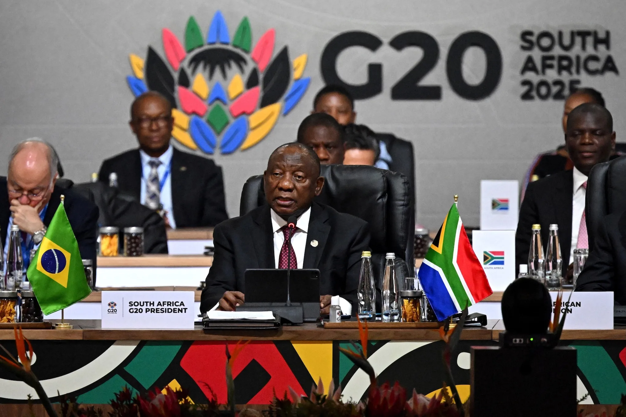 The Group of 20 summit in South Africa adopted a joint declaration on climate action, debt relief, and broader global challenges, despite the absence of the United States and differing views among several members. The document was completed after negotiations that proceeded without U.S. involvement, marking a departure from the G20’s traditional reliance on full consensus. South African officials said the text could not be renegotiated, noting that it reflected months of work and that participating members had reached what they considered sufficient agreement.
